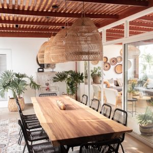 a large wooden table surrounded by black chairs
