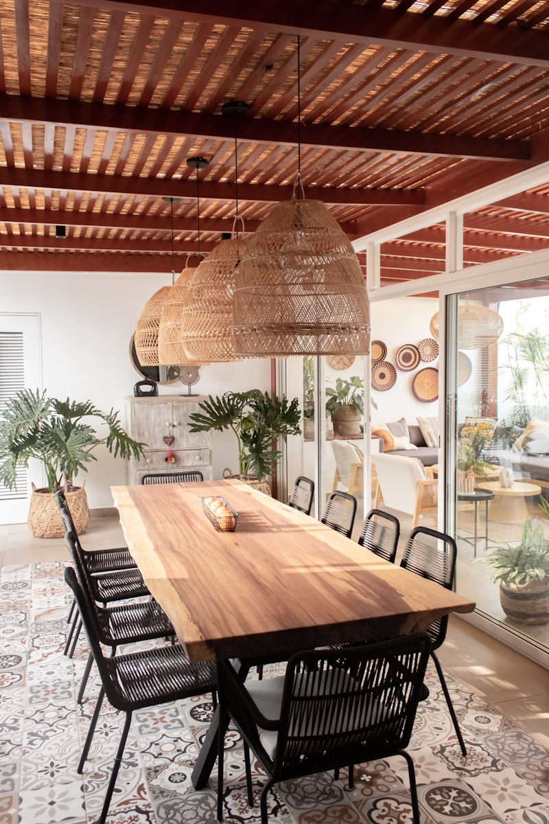 a large wooden table surrounded by black chairs